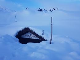 The FÍ chalet, buried in snow.