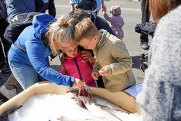 Children getting education about fish in a playful real life setting.