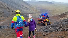 The daughter held on to her mother's shoes while walking down with a rescue team member while the mother was driven down the mountain in a buggy car.