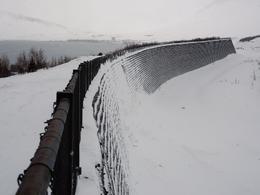 Here you can see the cross 17 metre high cross barrier last Monday, March 27th, below Drangagil gorge in Neskaupstaður. The avalanche hit the cross barrier at immense speed and the snow was caught in the barrier and was thrown up into the air. Last Thursday another avalance was heeding the same way but was halted before it hit the barrier.