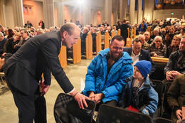 Guðni Th. Jóhannesson, the President of Iceland, talks to the six year old boy Hlynur Breki Steinarsson and his father, Steinar Smári Einarsson at a meeting from the residents of Grindavík last Sunday in Hallgrímskirkja church in Reykjavík.