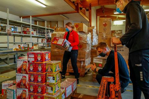 Rescue workers getting fireworks ready for sale.