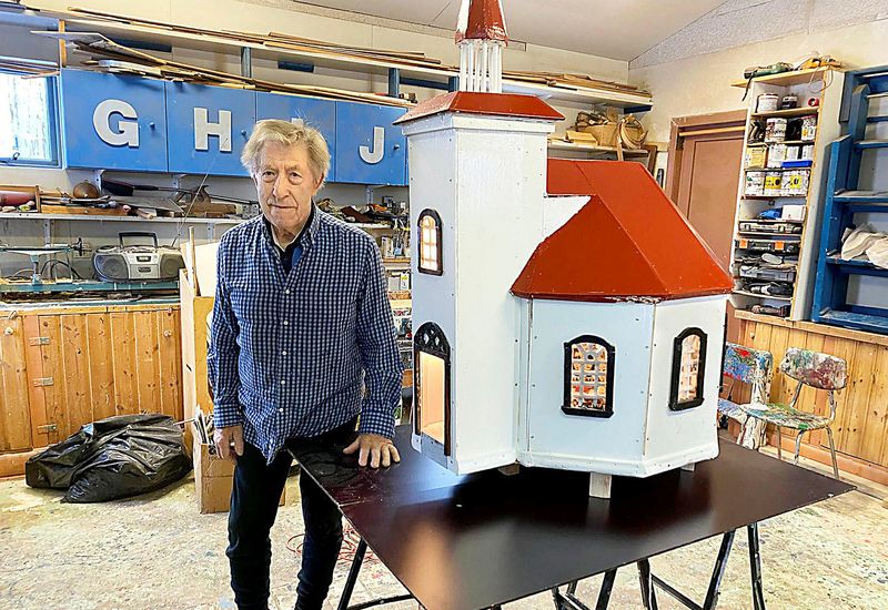 Árni Bjarnason, standing next to his model of Silfrastaðakirkja church.