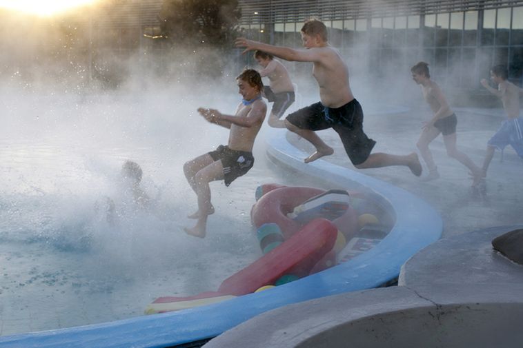 Boys jumping into a Reykjavik swimming pool in the middle of winter.