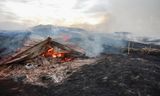 Tvö hús, gamalt útihús og hlaða urðu eldinum að bráð.